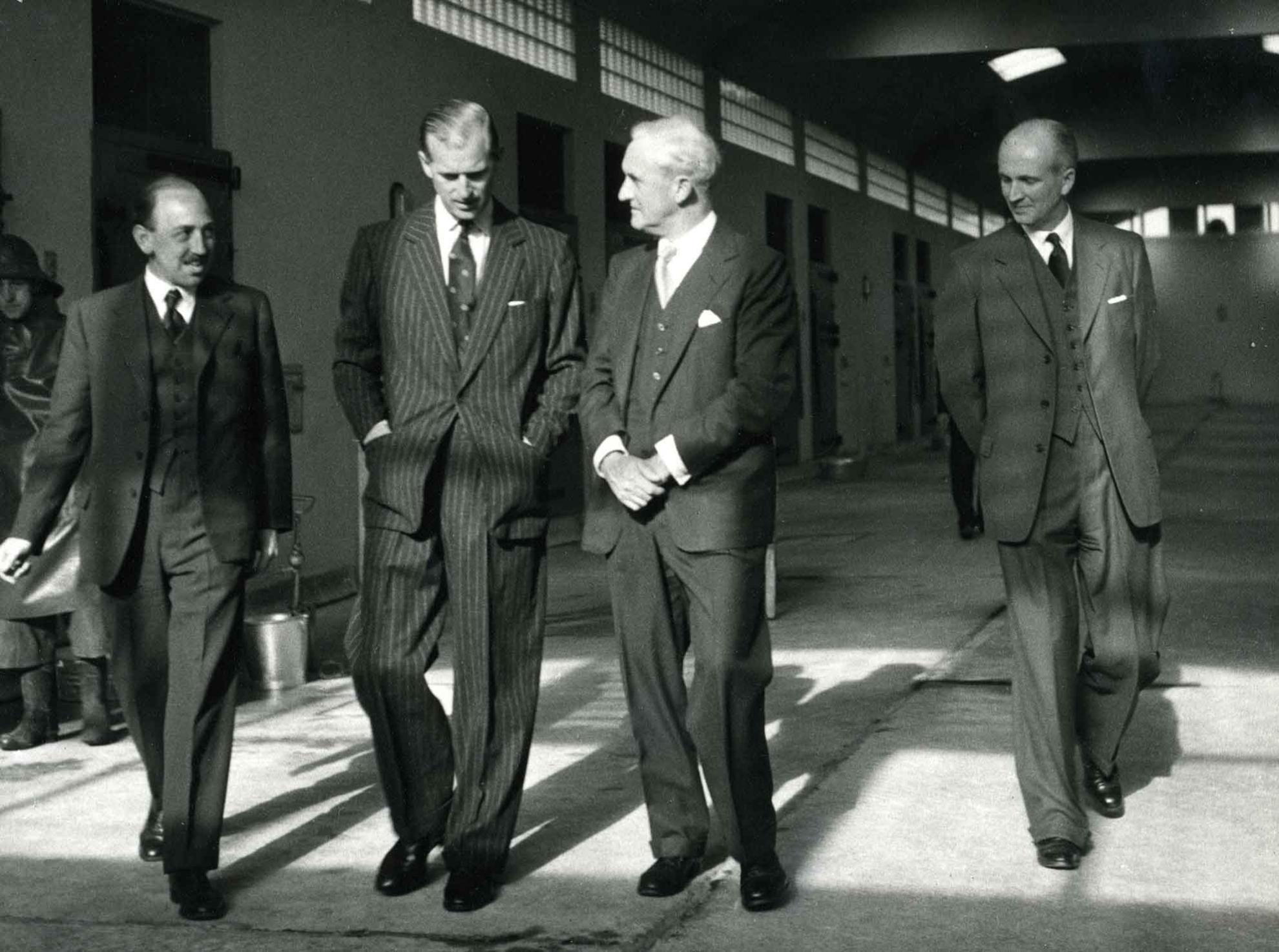 HRH Prince Philip, The Duke of Edinburgh, walks with 3 Pirbright staff on a 1956 visit